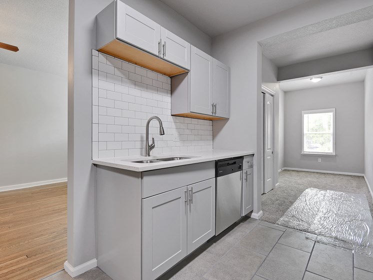 Image of kitchen with stainless steel appliances, new cabinets, and exposed brick