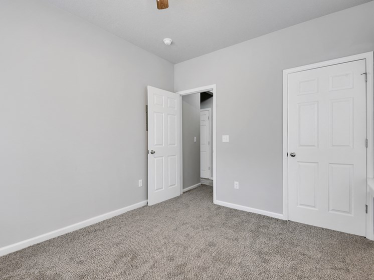 image of large bedroom with new carpeting and ceiling fan