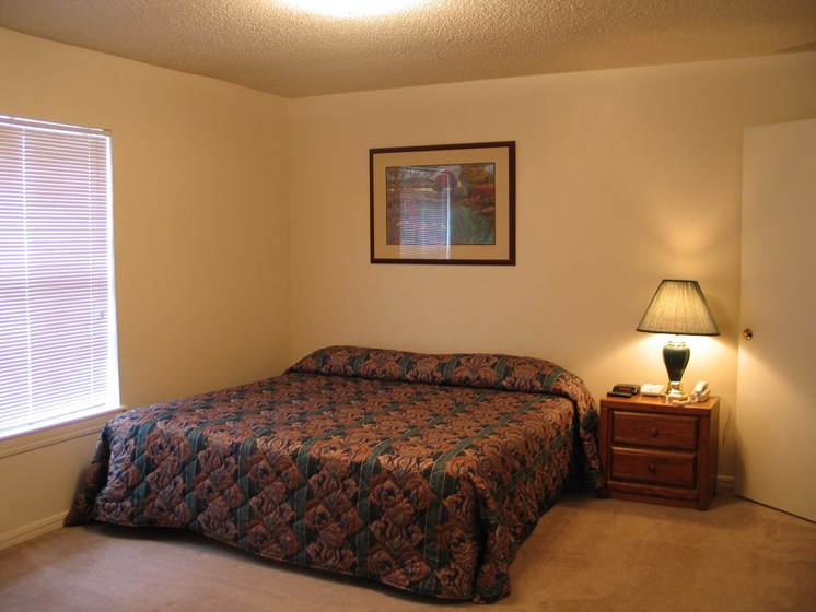 Image of a bedroom with bed and nightstand