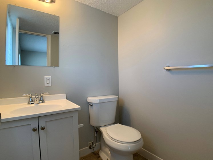 half bathroom with toilet and vanity