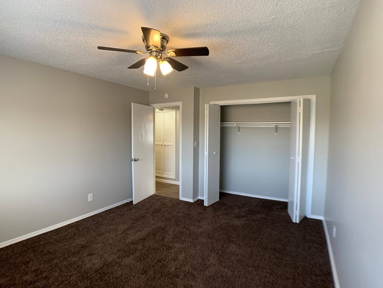 bedroom with large closet and ceiling fan