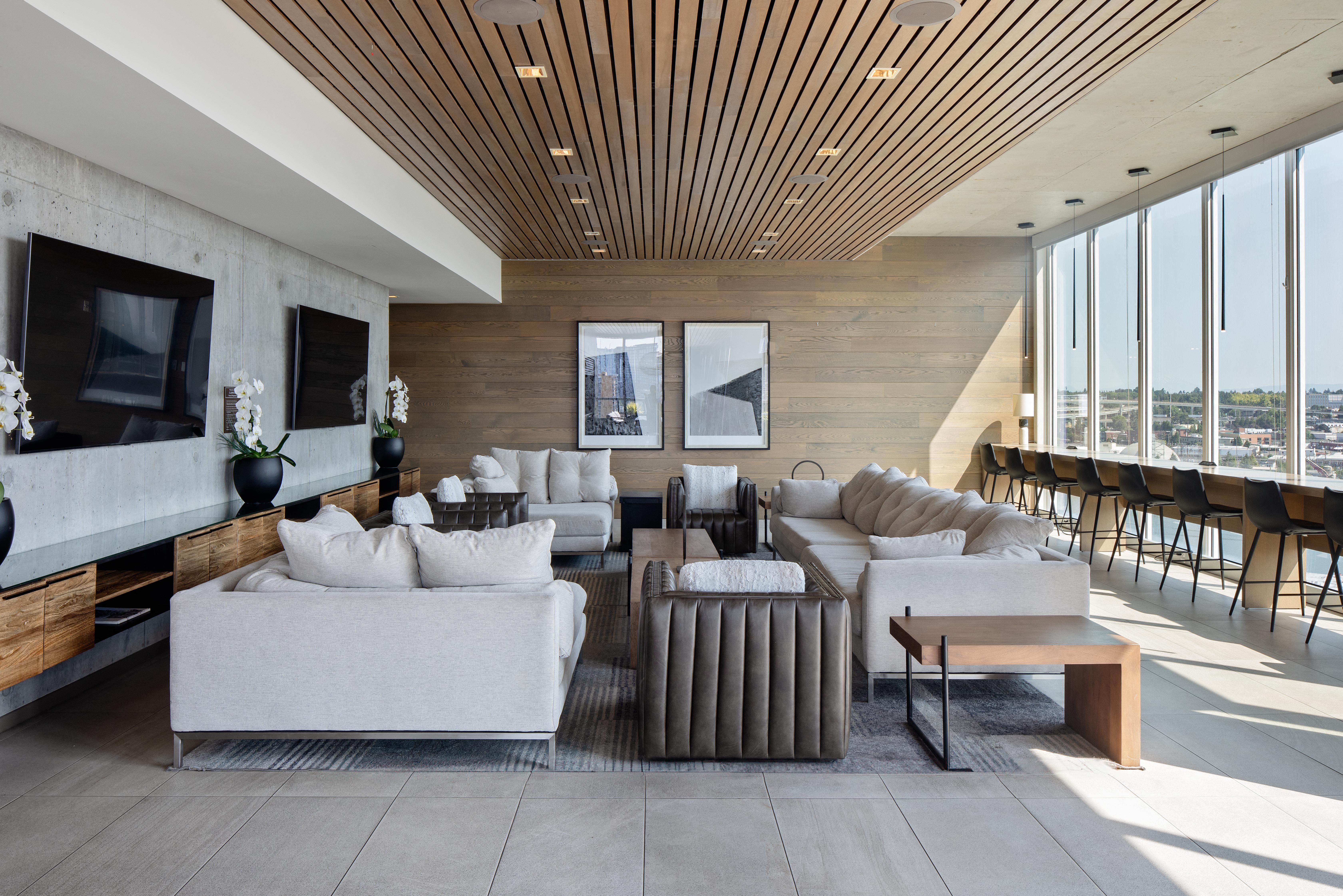 a living room with couches and chairs and a large window