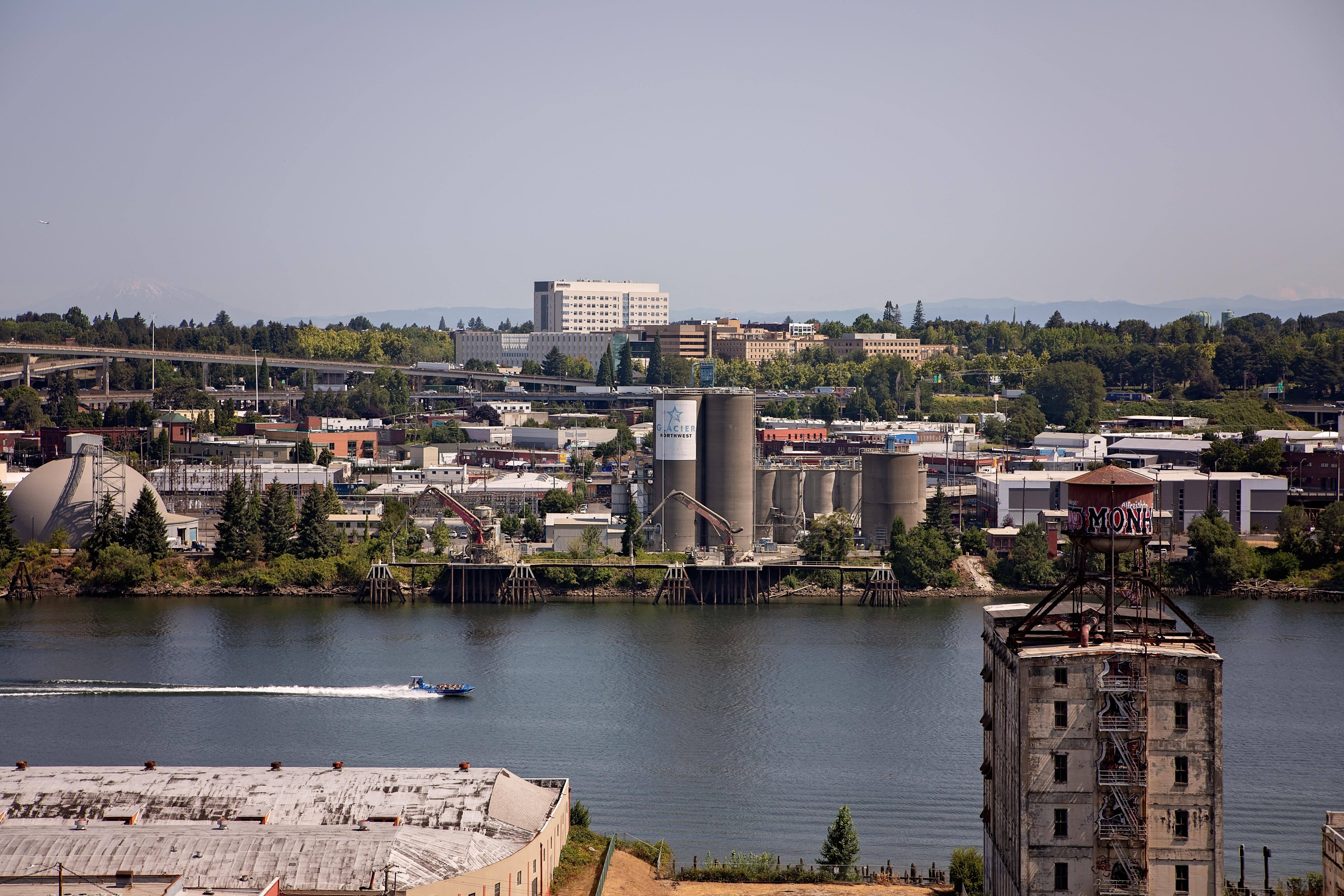 a boat in the water near a river and a city