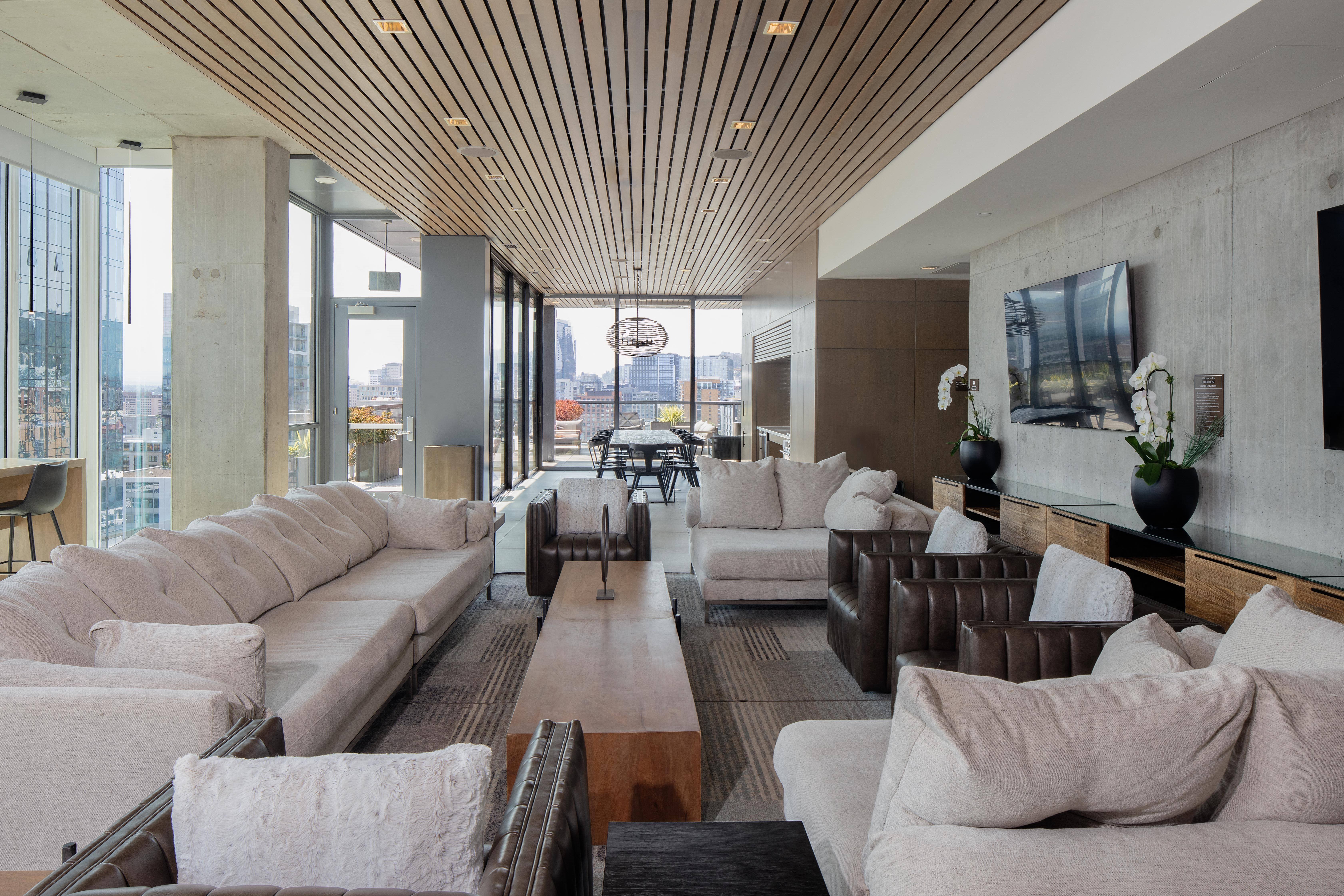 a large living room with couches and chairs and a large window