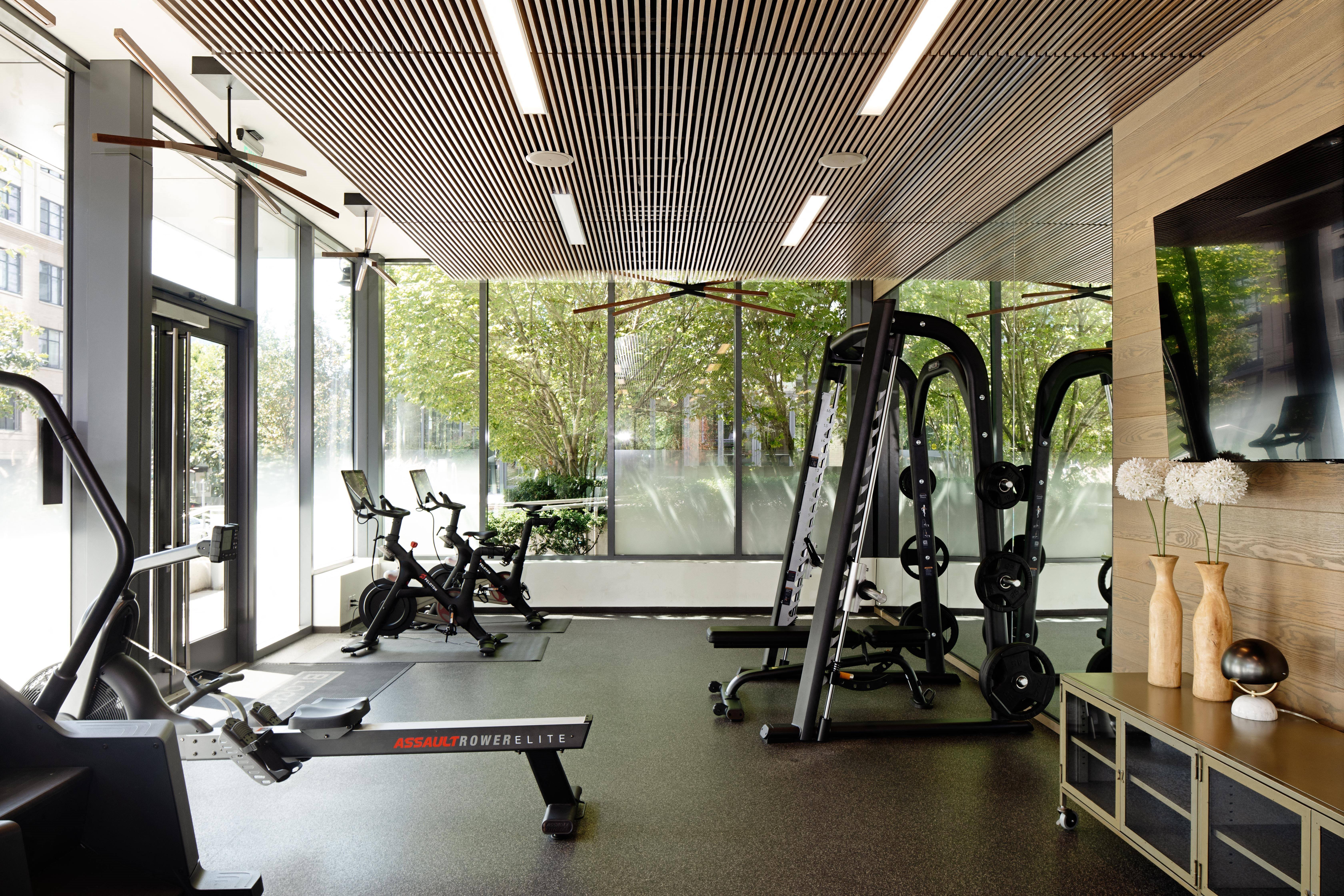 a gym with glass walls and a view of the outdoors