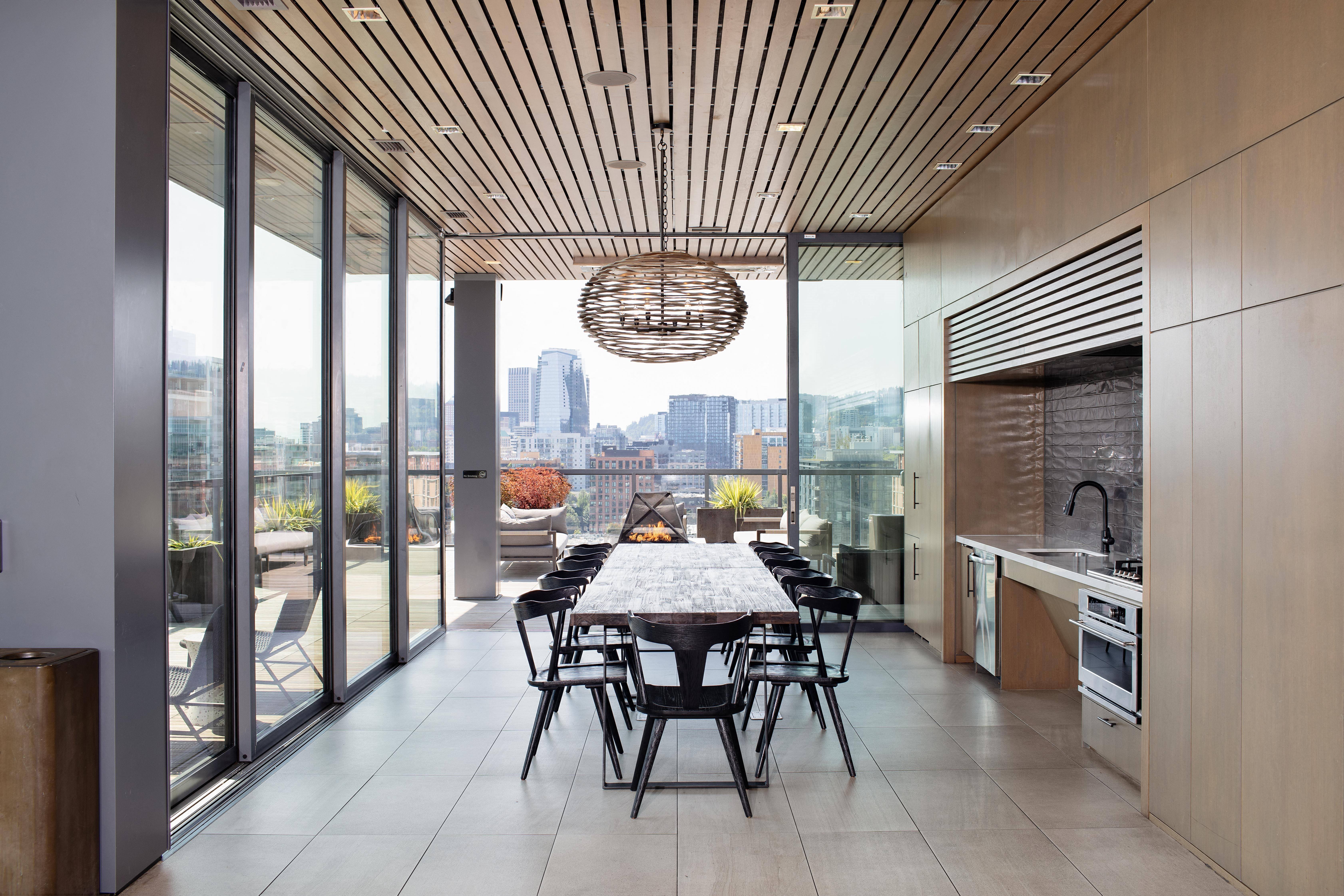 a large dining room with a long table and a city view