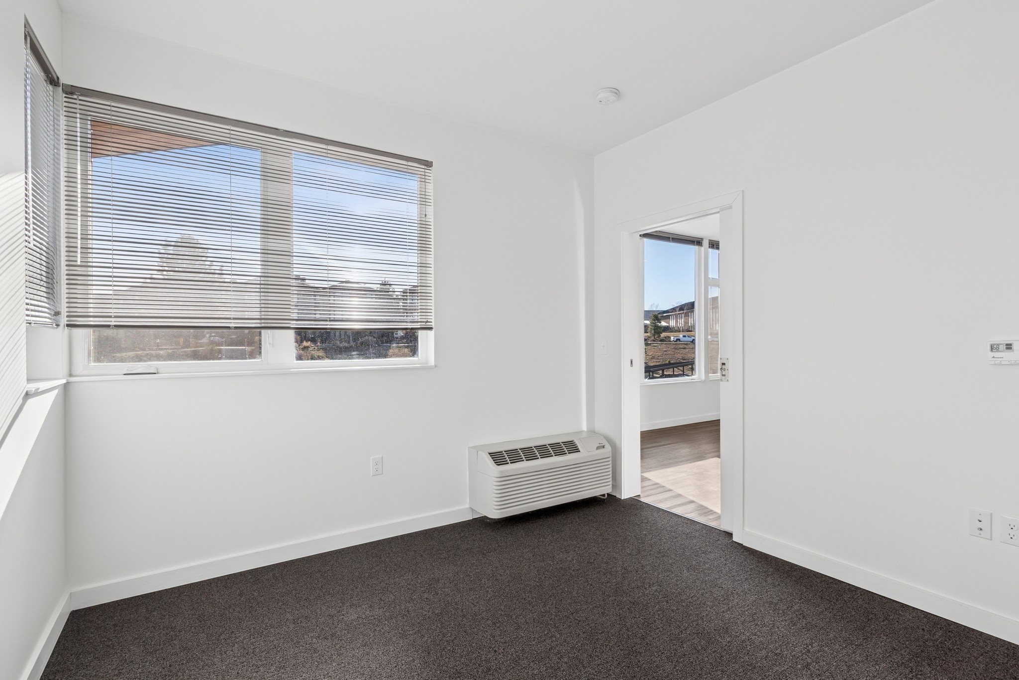 A room with a window and a door.
