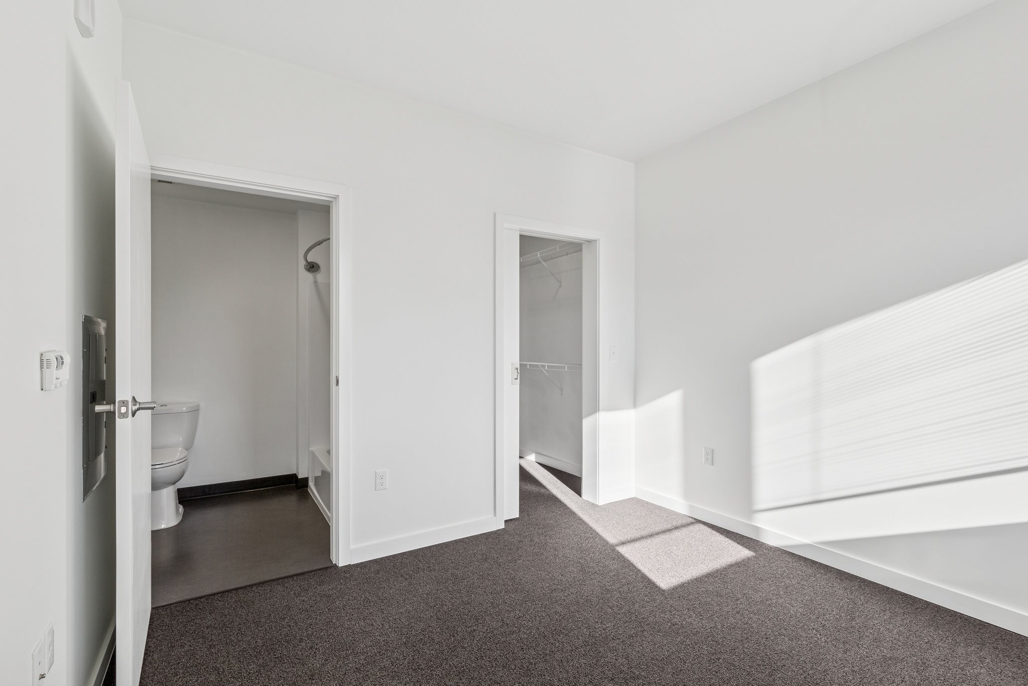 A white bathroom with a toilet and sink.