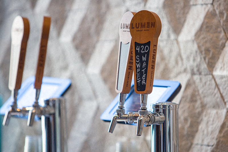 Tap handles at the complimentary coffee & craft beer bar.