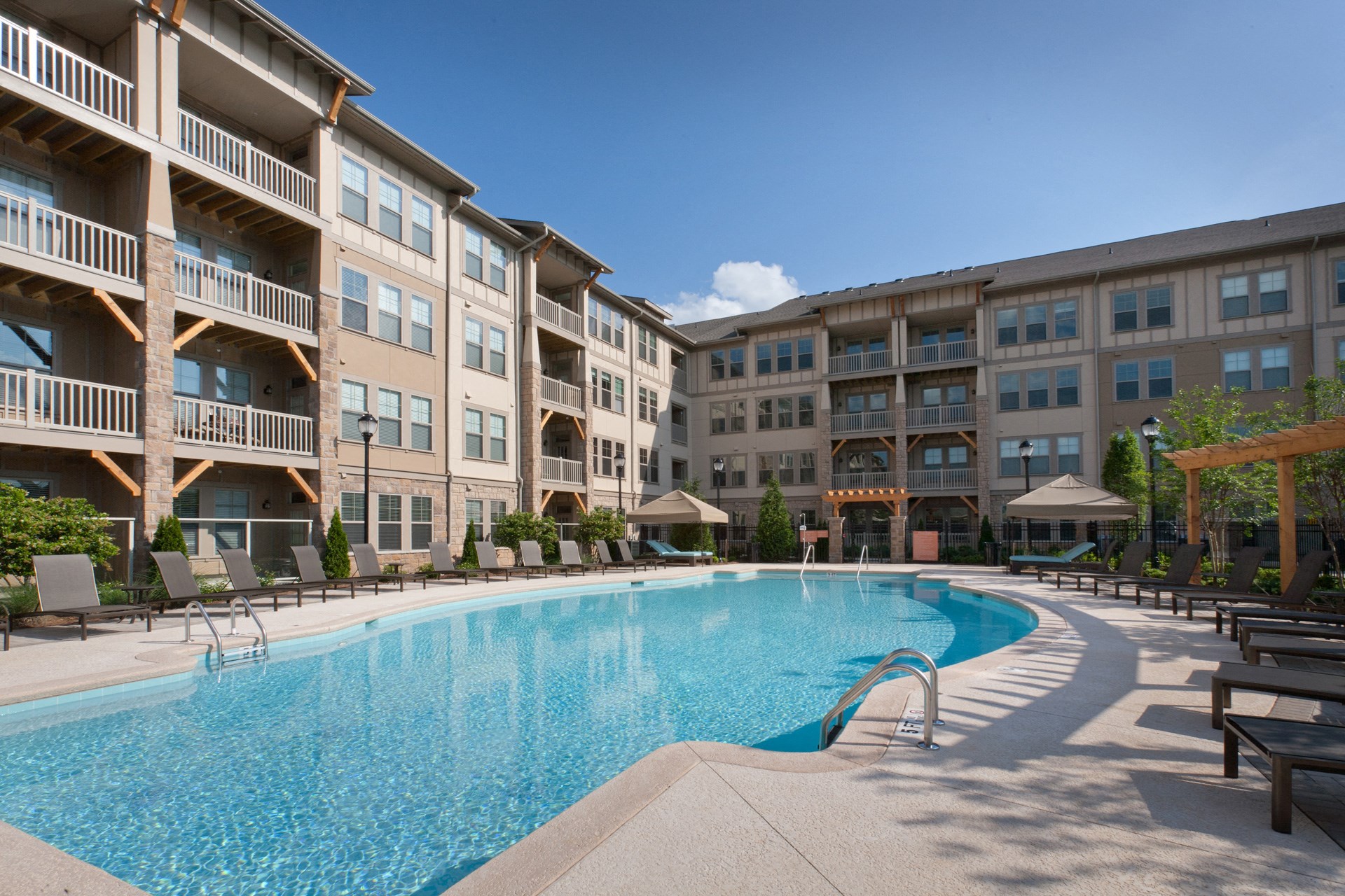 Pet Friendly Apartments in Johns Creek - The Regency at Johns Creek Walk Apartments Pool with Sun Chairs