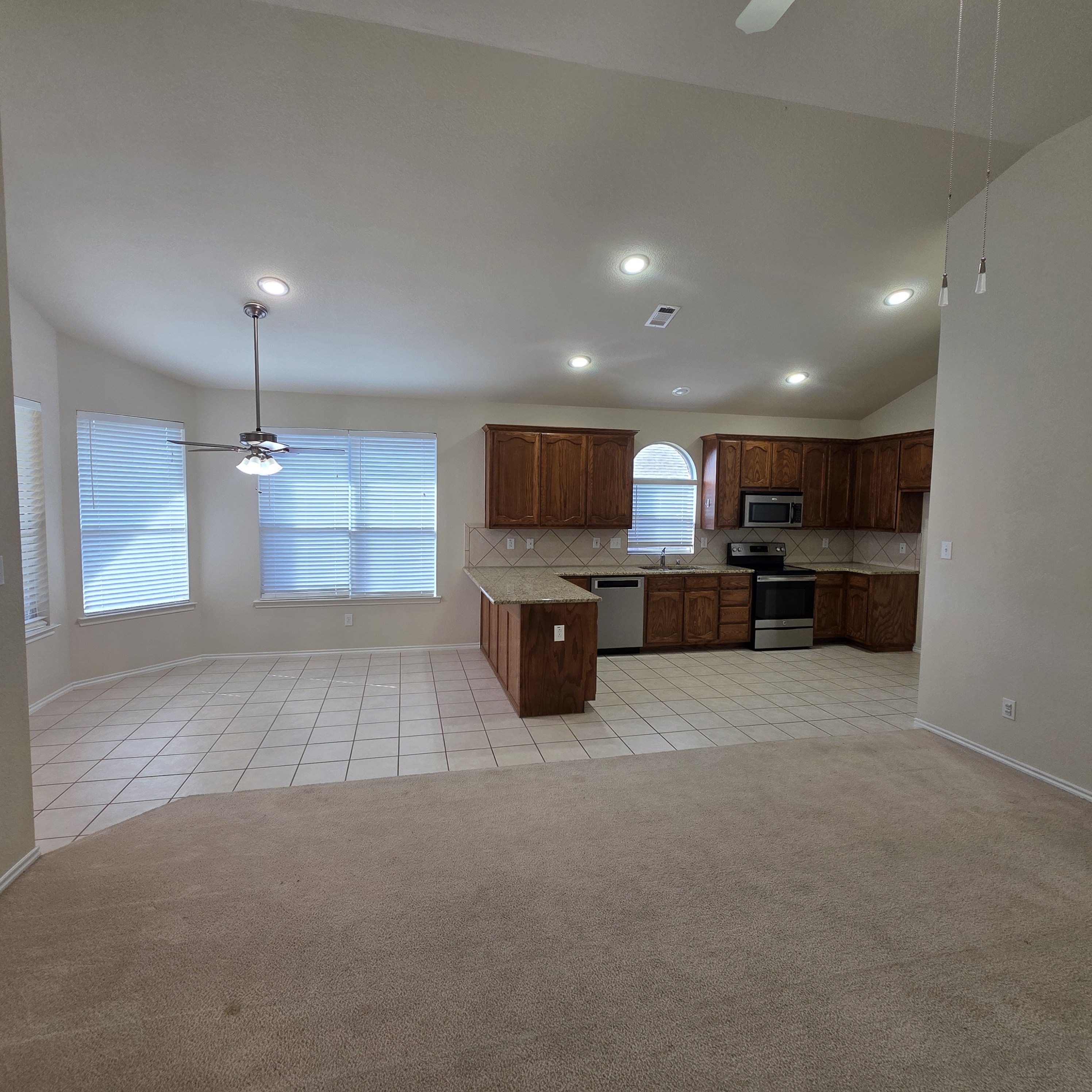 A kitchen with white cabinets and a countertop.