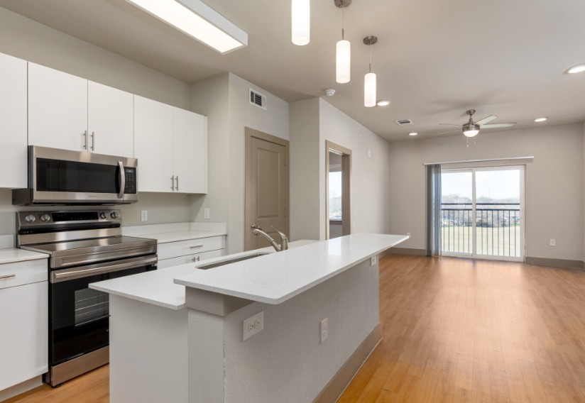 A modern kitchen with white cabinets and a large island.
