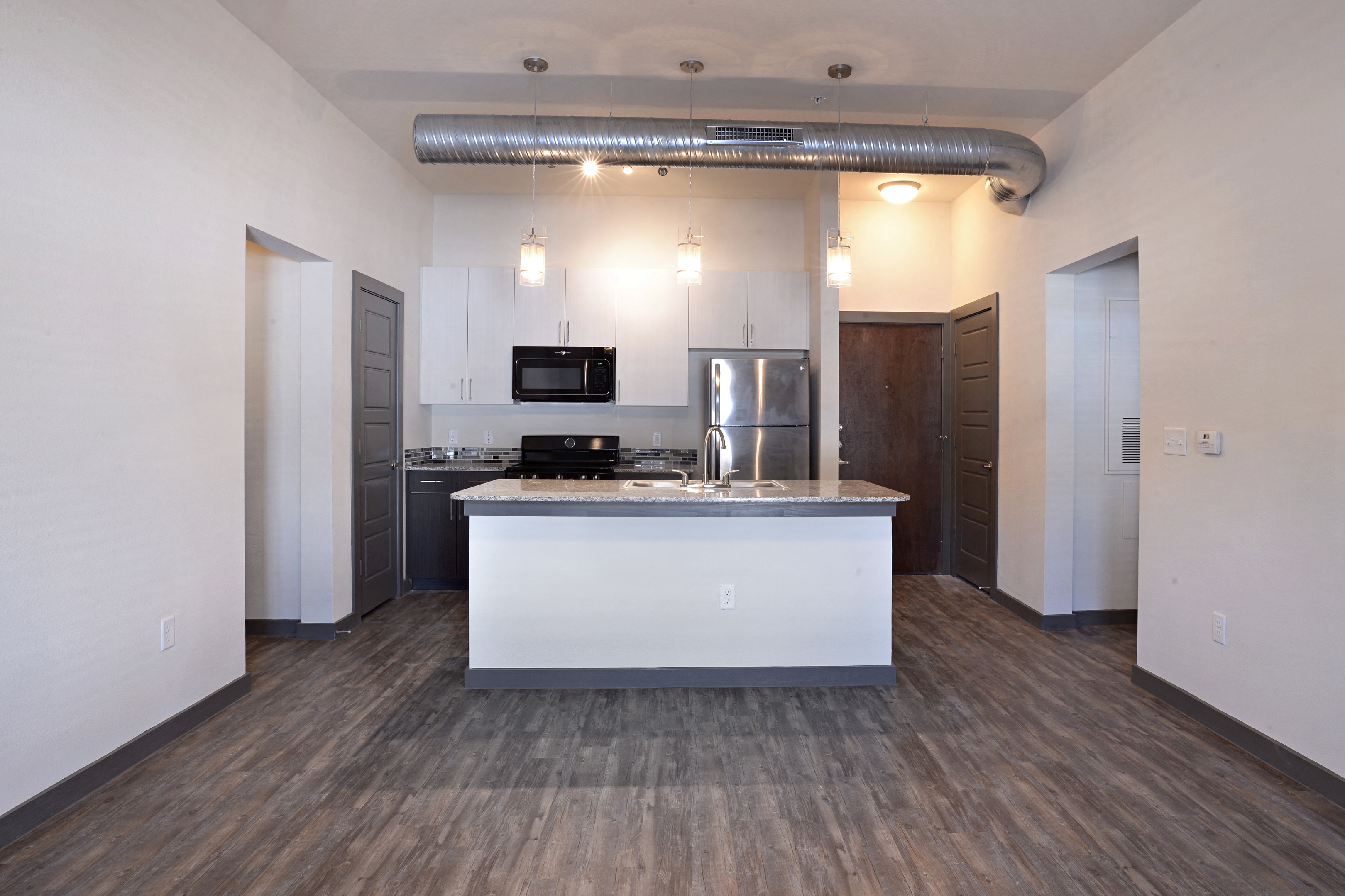 Kitchen with lights at East End Lofts at the Railyard Apartments, Denton, Texas