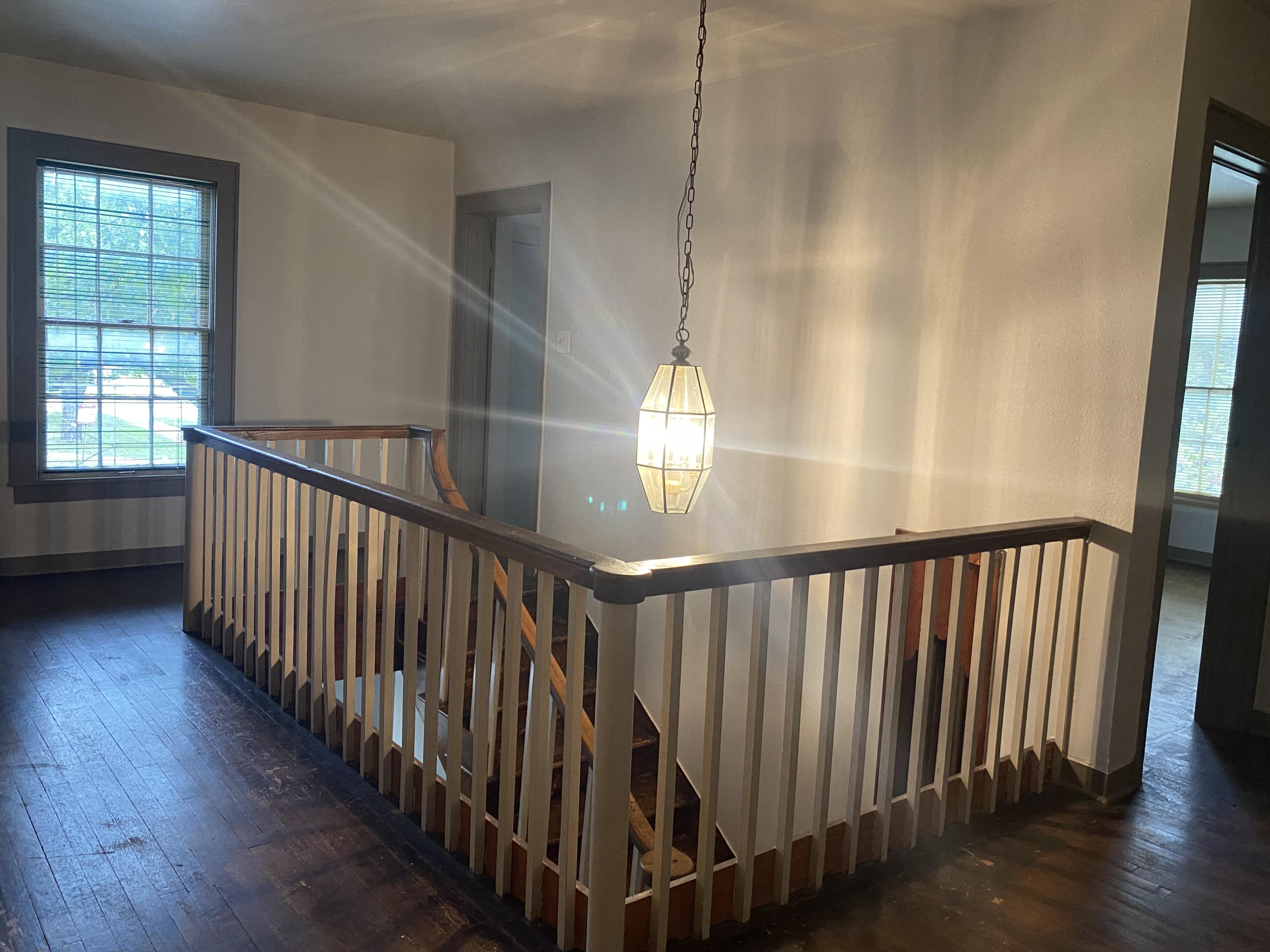 arial view of a landing with a wooden railing and a light fixture