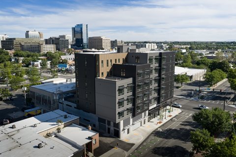 A modern building with a parking lot in front of it.