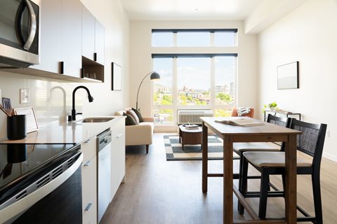 A modern kitchen with a dining table and chairs.