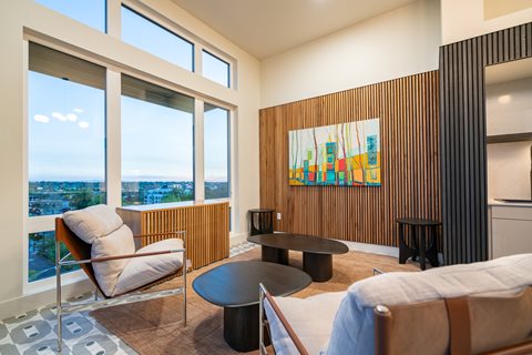 A living room with a large window overlooking the city.
