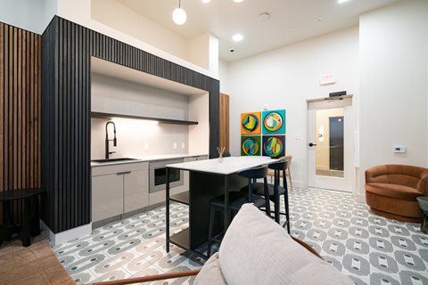 A modern kitchen with a black and white tiled floor.