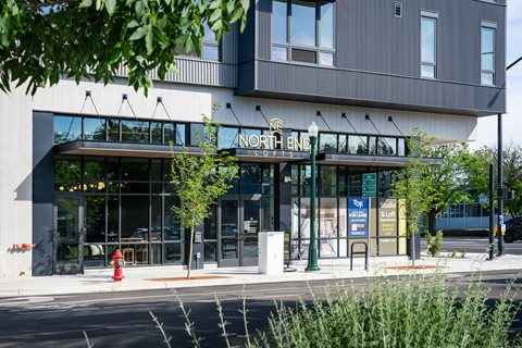A modern building with a glass entrance and a sign that reads 