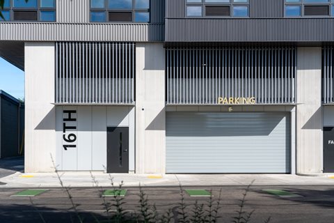 A building with a parking sign on the side.