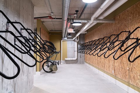 A long hallway with bicycles on the racks.