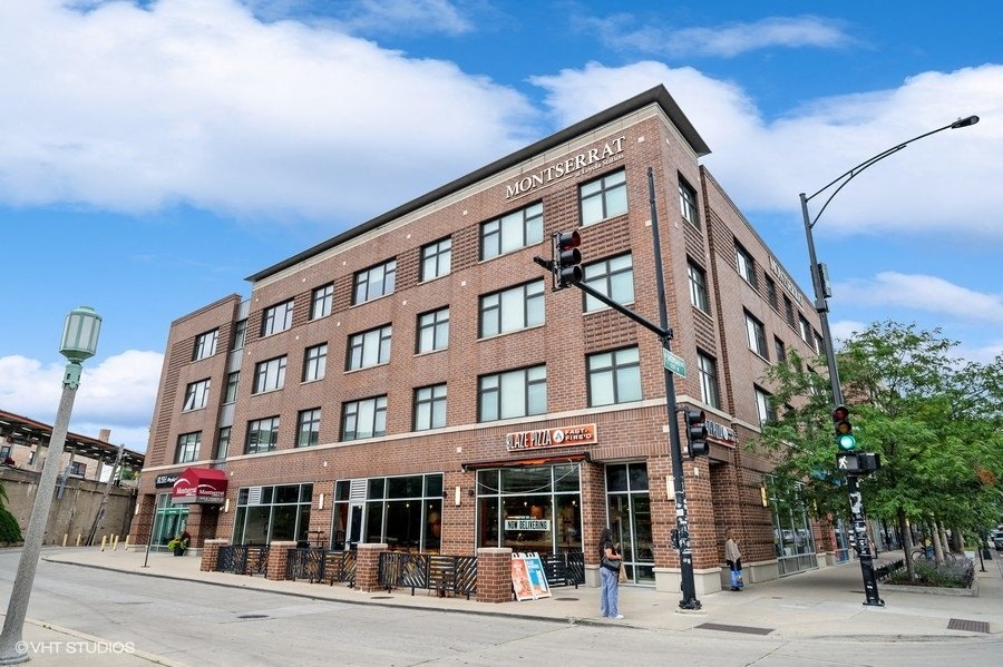 a large brick building on the corner of a city street