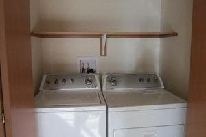 Image of washer and dryer and shelf above