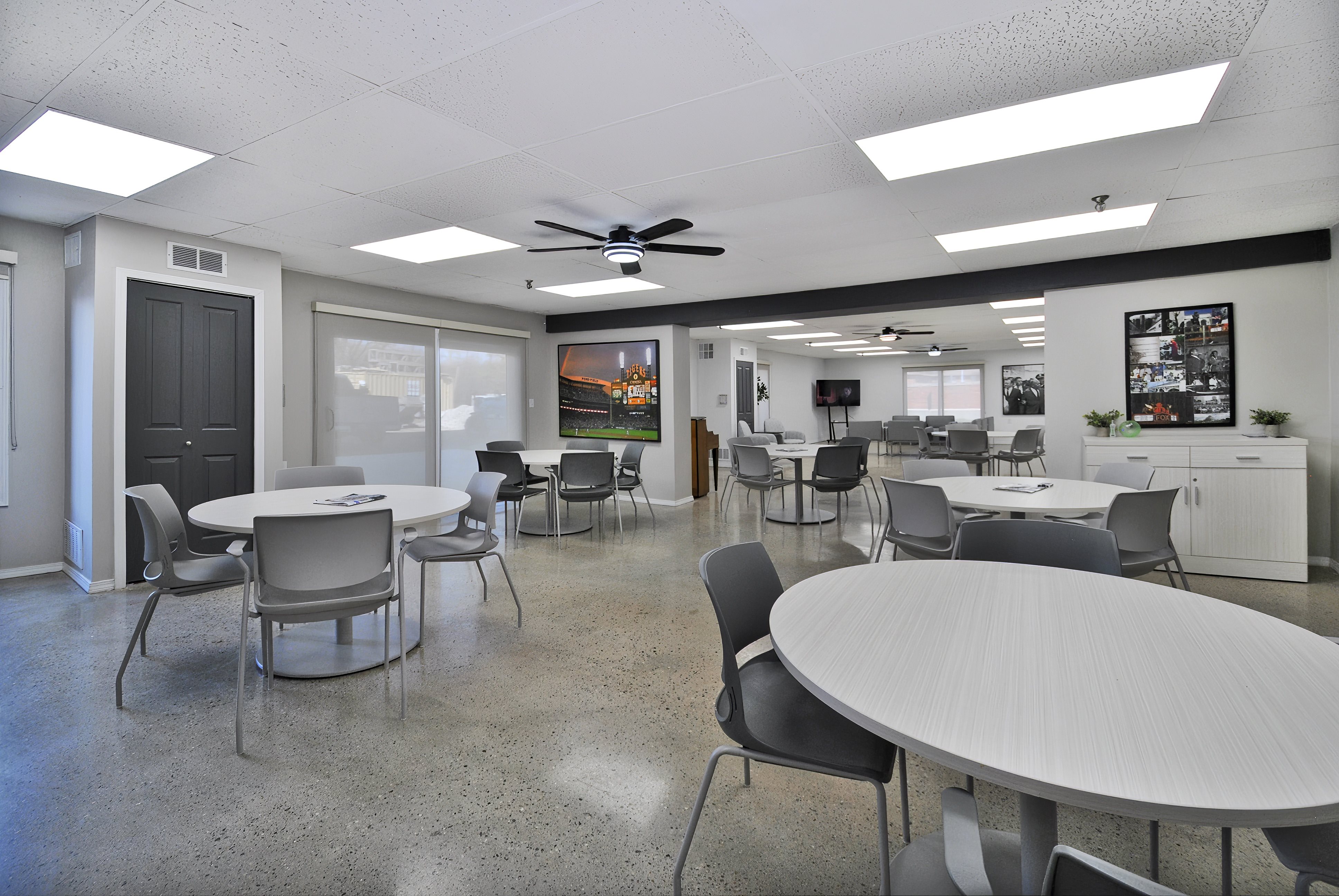 A conference room with a white table and chairs.