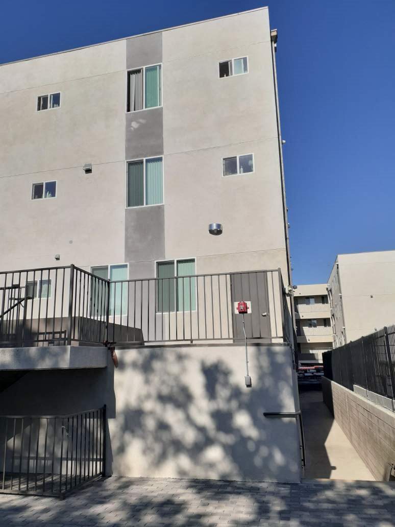 A modern building with a balcony and a fire escape.