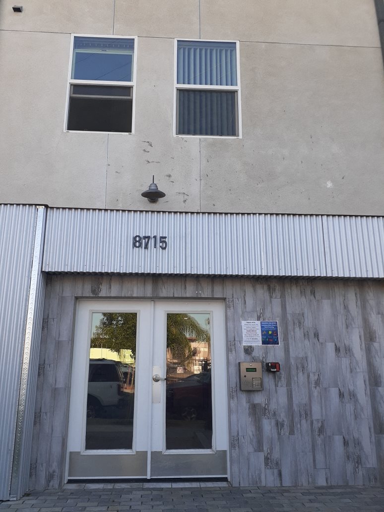 A building with the number 8715 on the corner.