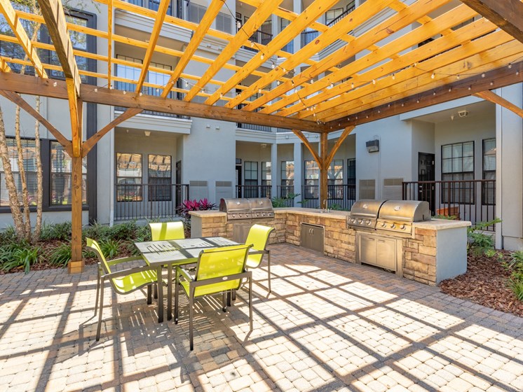Courtyard pool BBQ Grill area with outdoor seating.