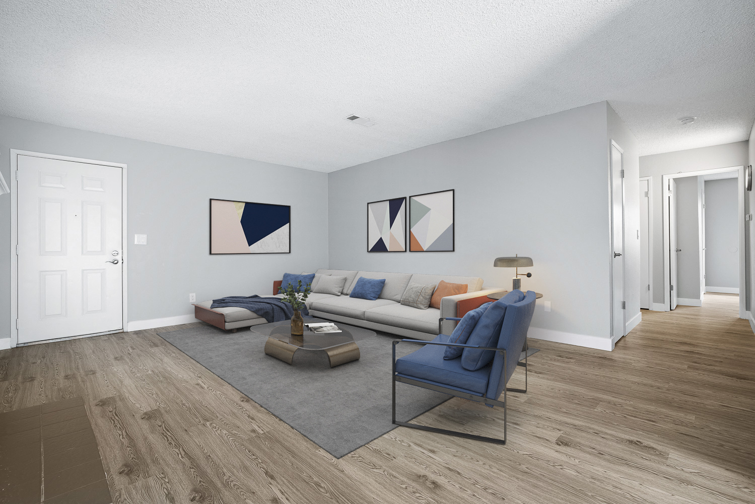 A living room with a blue couch and a coffee table.