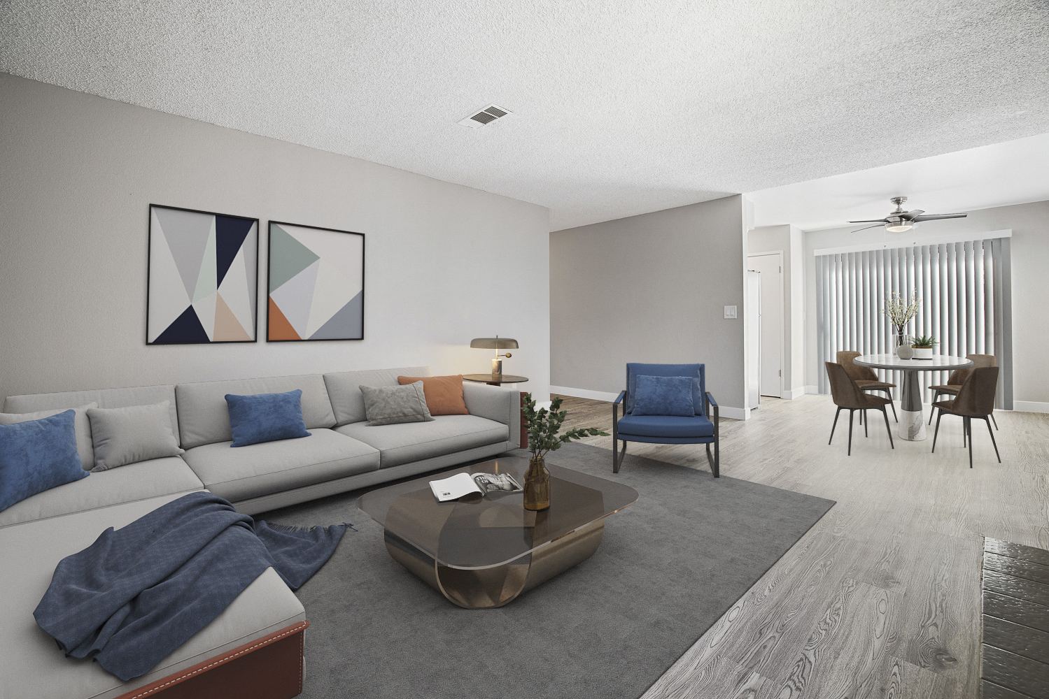 A living room with a grey sofa, a blue chair, and a coffee table.