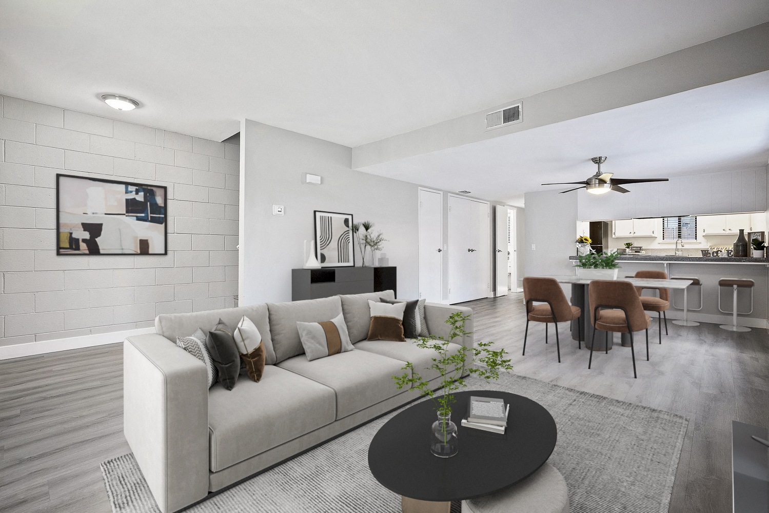 A modern living room with a grey couch and a coffee table.