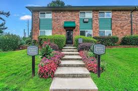 A brick building with a green awning and a sign that says "Fairway Apartments".,A brick building with a green awning and a sign that says "Fairway Apartments".