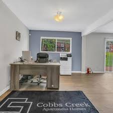 A room with a desk and a chair in it.,A room with a desk and a chair in it.