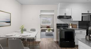 A modern kitchen with a dining table set for four.,A modern kitchen with a dining table set for four.