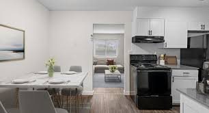 A modern kitchen with a dining table set for four.