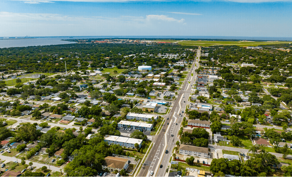 A bird's eye view of a residential area with a road running through it.
