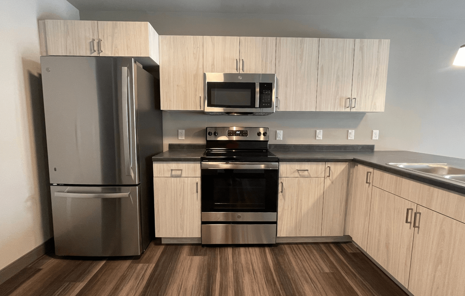 a kitchen with a stainless steel refrigerator freezer and a stove top oven