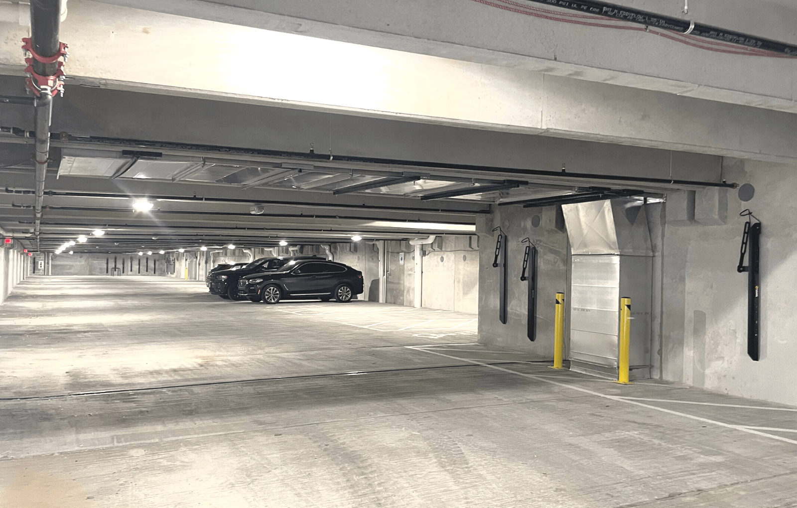 a parking garage with three cars
