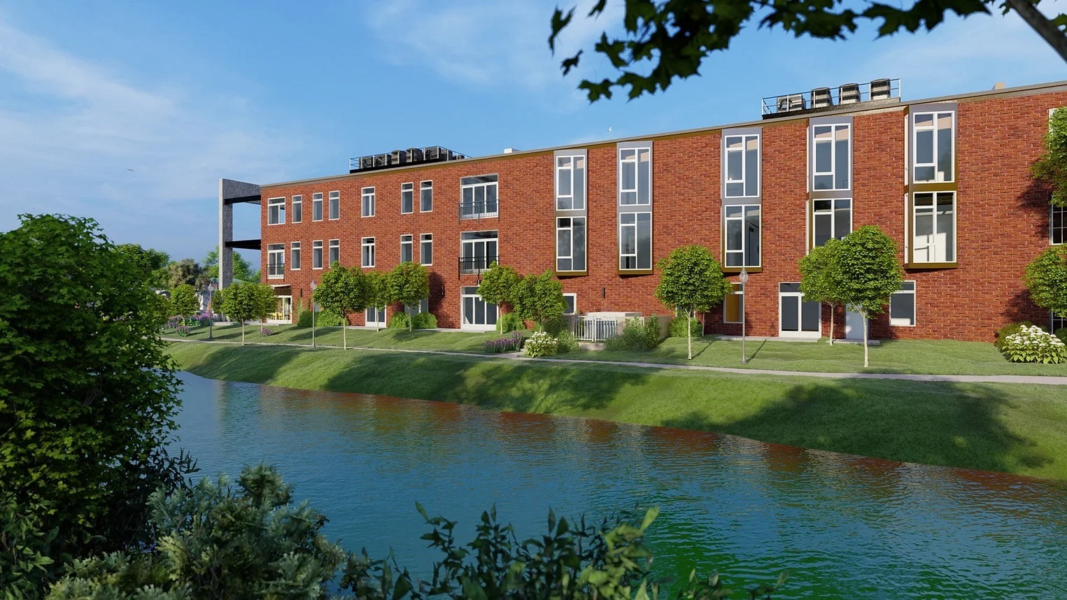a large brick building next to a body of water