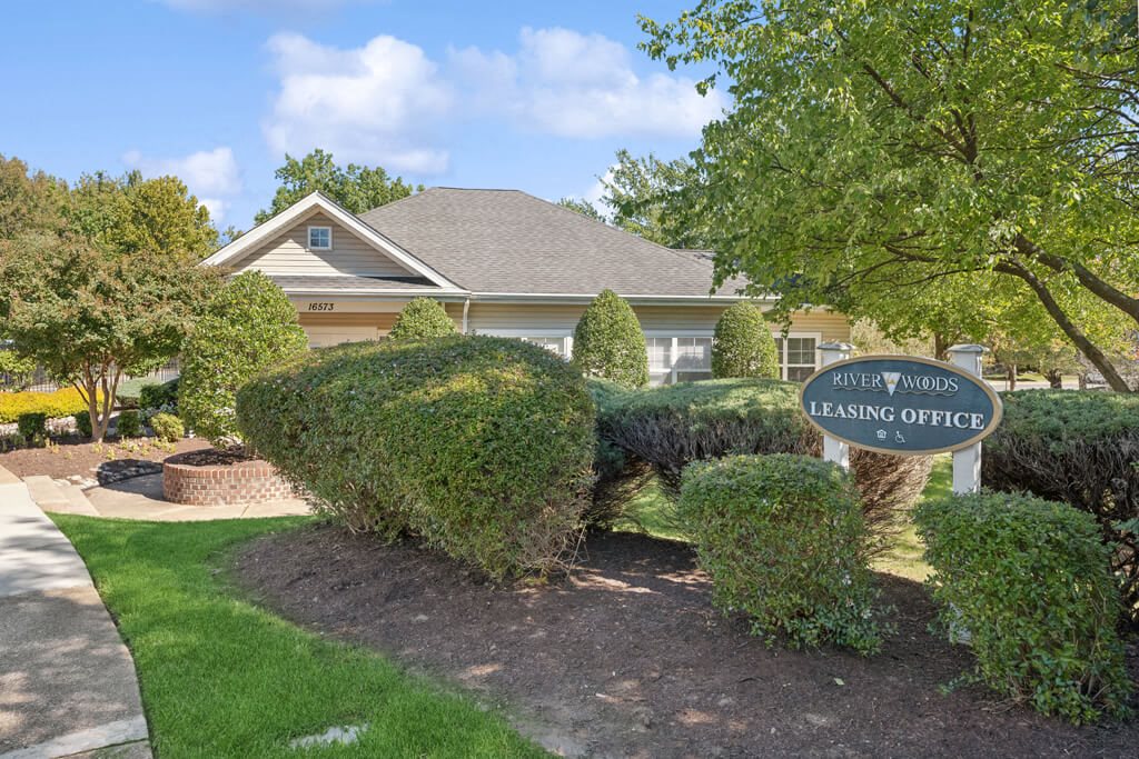 the front of a house with a leasing office sign