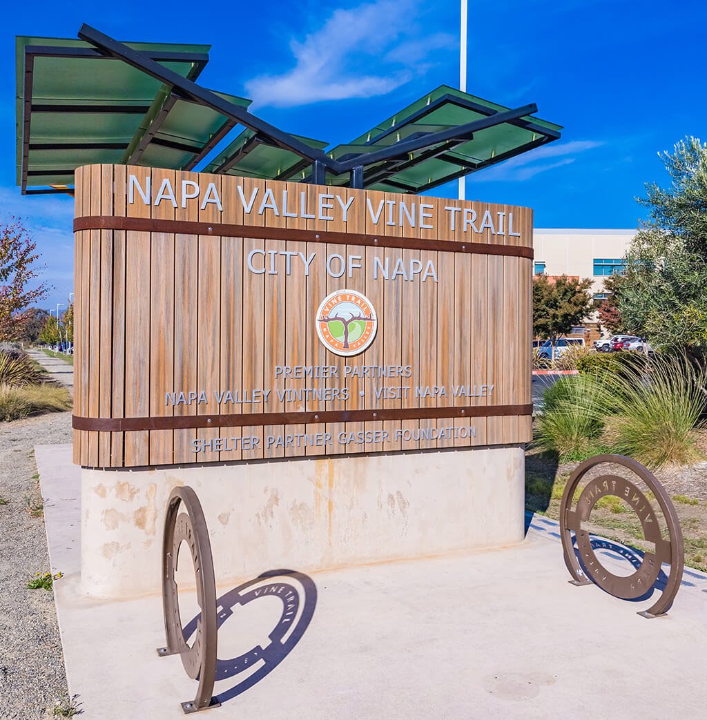A sign for the Napa Valley Vine Trail is shown in front of a building