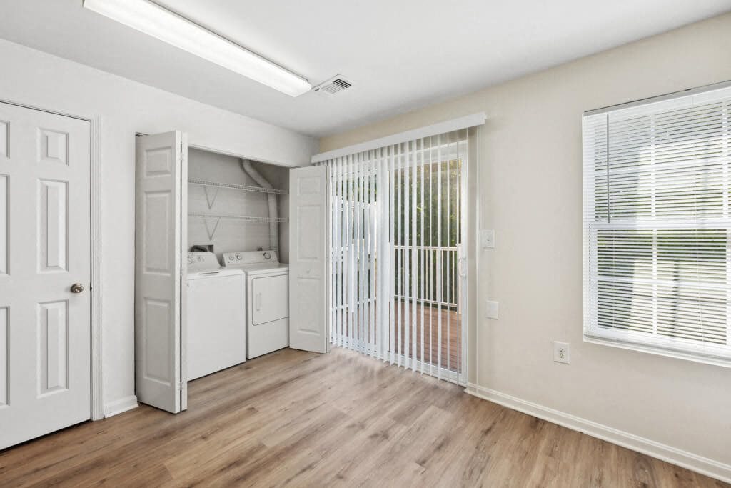 an empty room with a laundry room and a closet