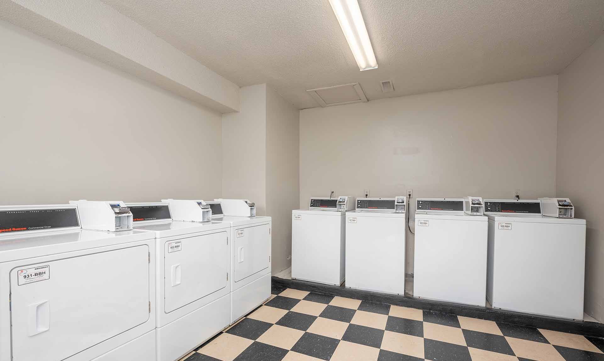 A row of washing machines in a laundromat.