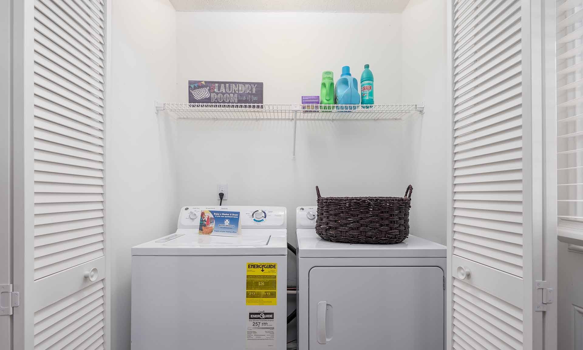 A small laundry room with a washer and dryer.