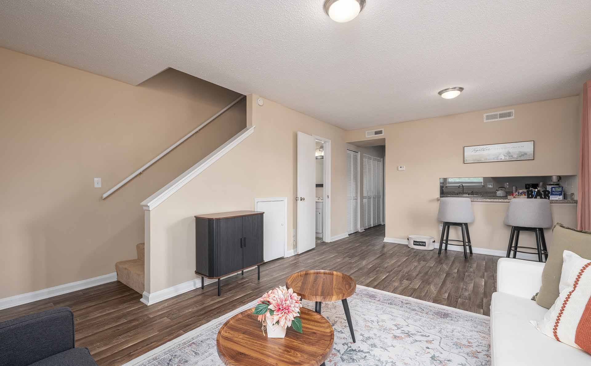 A living room with a staircase leading to the upper floor.