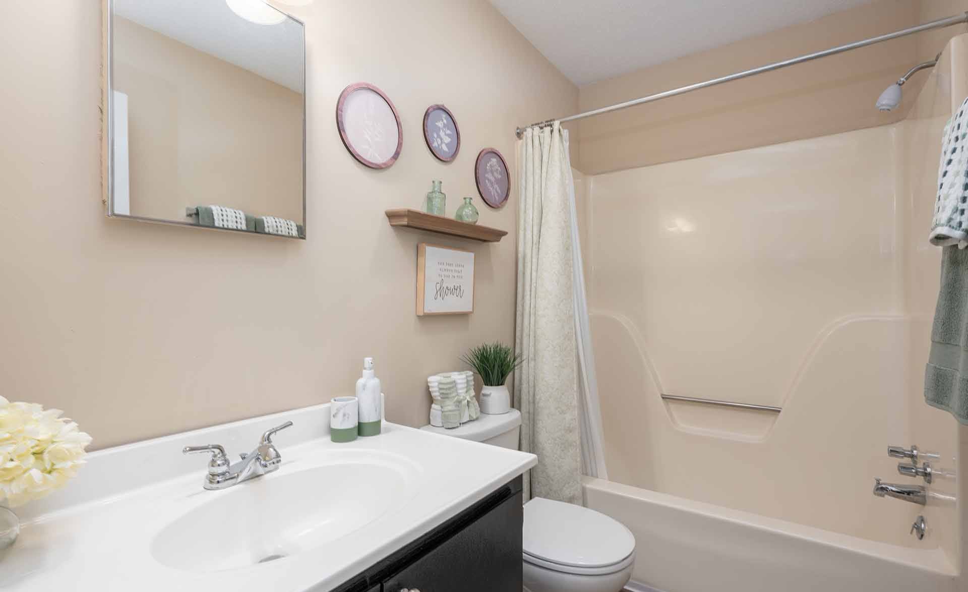 A bathroom with a white sink, toilet, and bathtub.