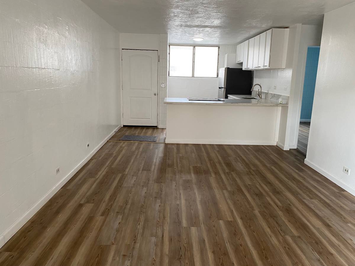 A room with wooden floors and white walls.